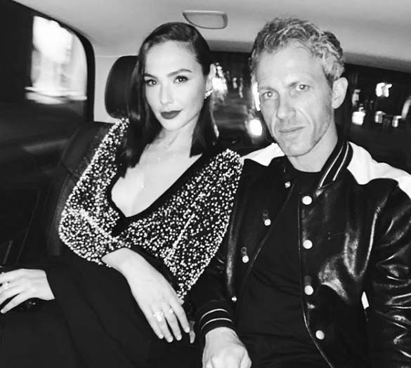Yaron Varsano taking a picture with his wife Gal Gadot inside a car.